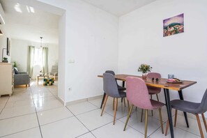 Enjoy meals in this stylish dining area with a wooden table and comfortable seating for four.