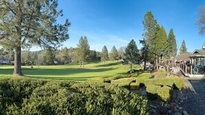 A golf course with a house in the background. - Yosemite Chalet, Golf Course Views, Game Room, Walk to Lake, Sleeps 12 (Groveland)