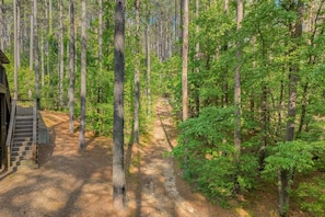 Wooded grounds with a natural path; property connects to authorized ATV trails. - Low Rider Lodge backed up to Forest with ATV Trail Access from Driveway (Broken Bow)