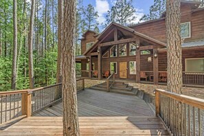 Front exterior with wide wooden deck walkway. - Low Rider Lodge backed up to Forest with ATV Trail Access from Driveway (Broken Bow)