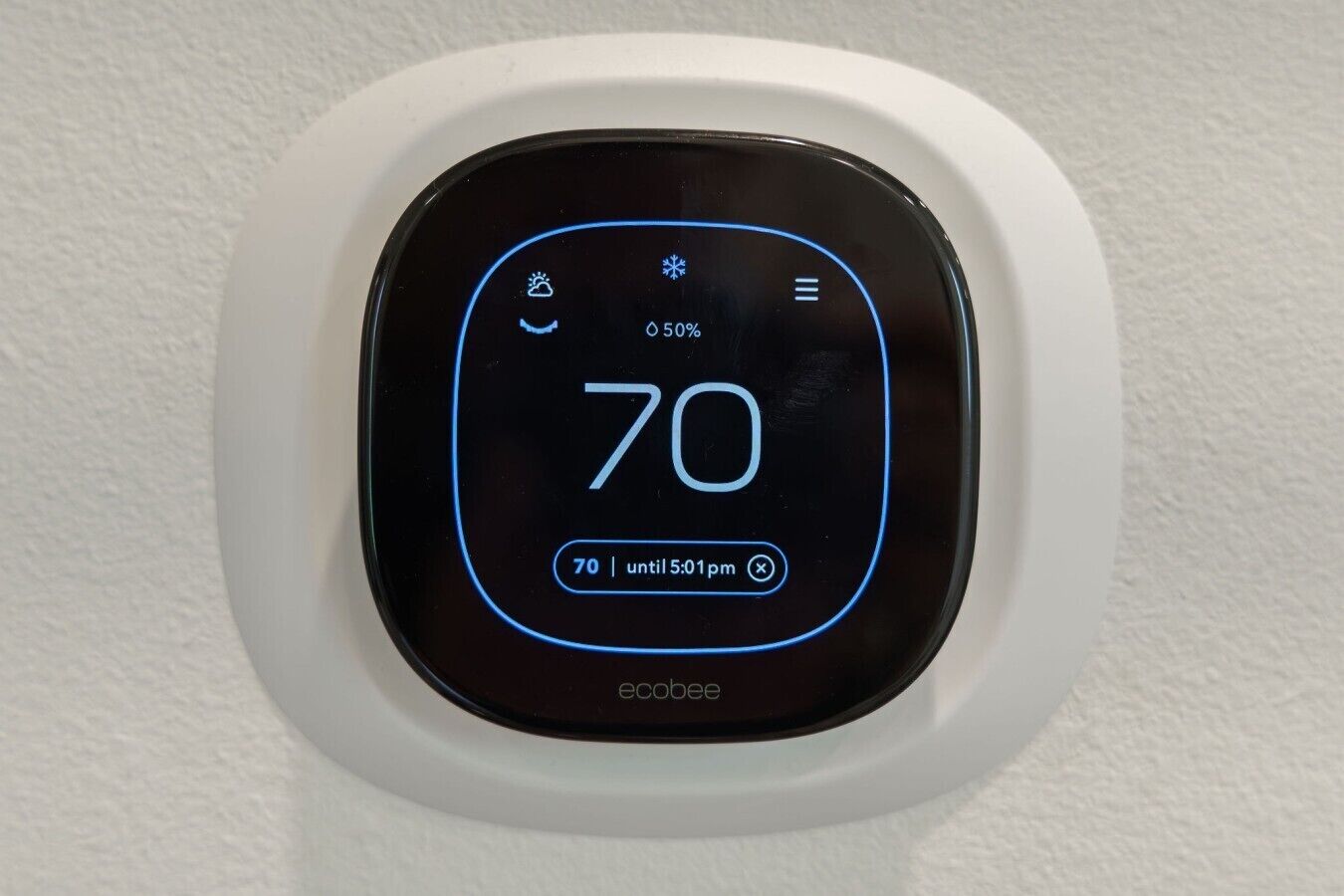 A thermostat displaying a temperature of 70 degrees Fahrenheit, with a timer set for 70 until 5:01 pm.