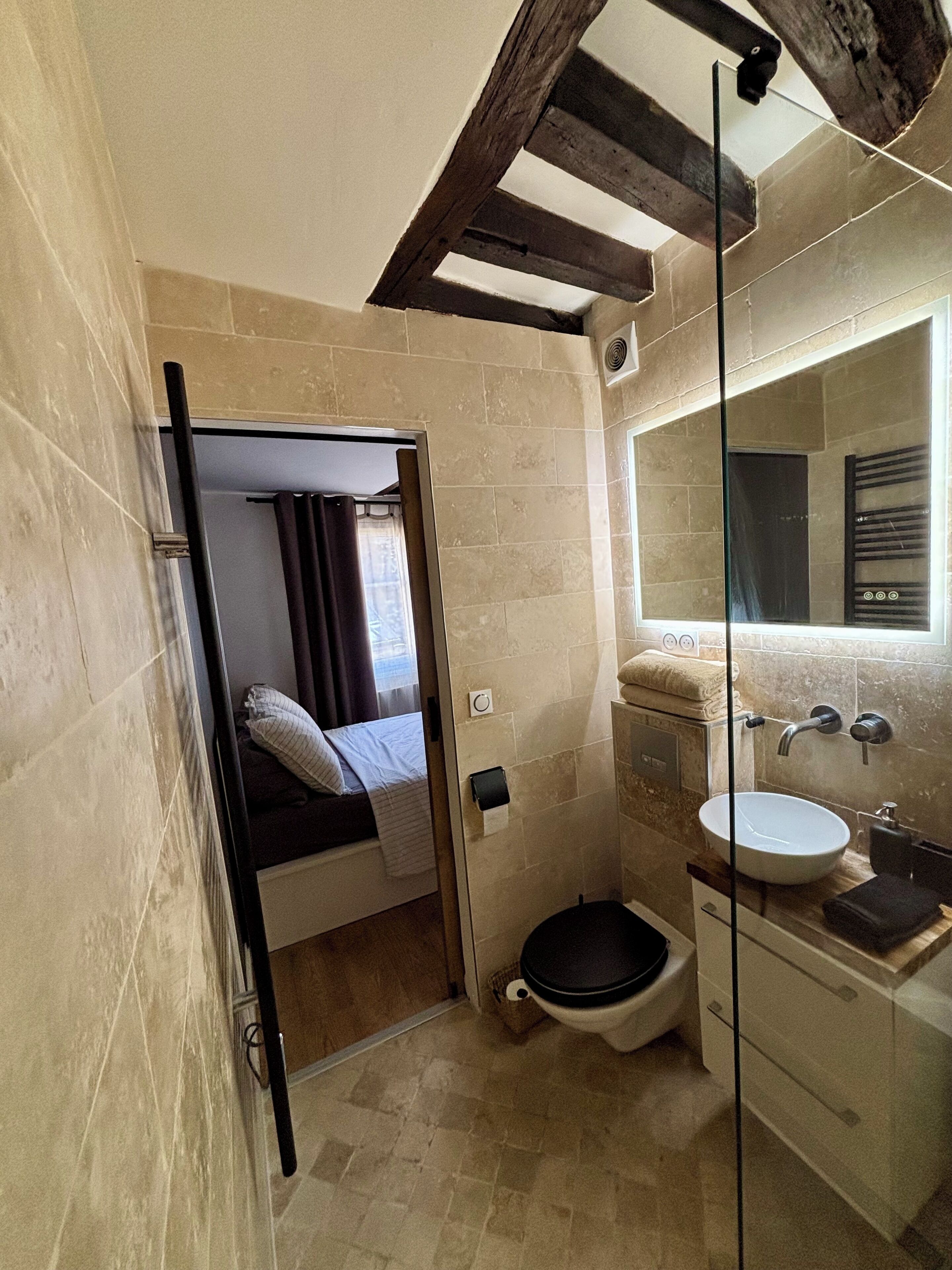 Ein kleines Badezimmer mit Dusche, Toilette und Waschbecken.