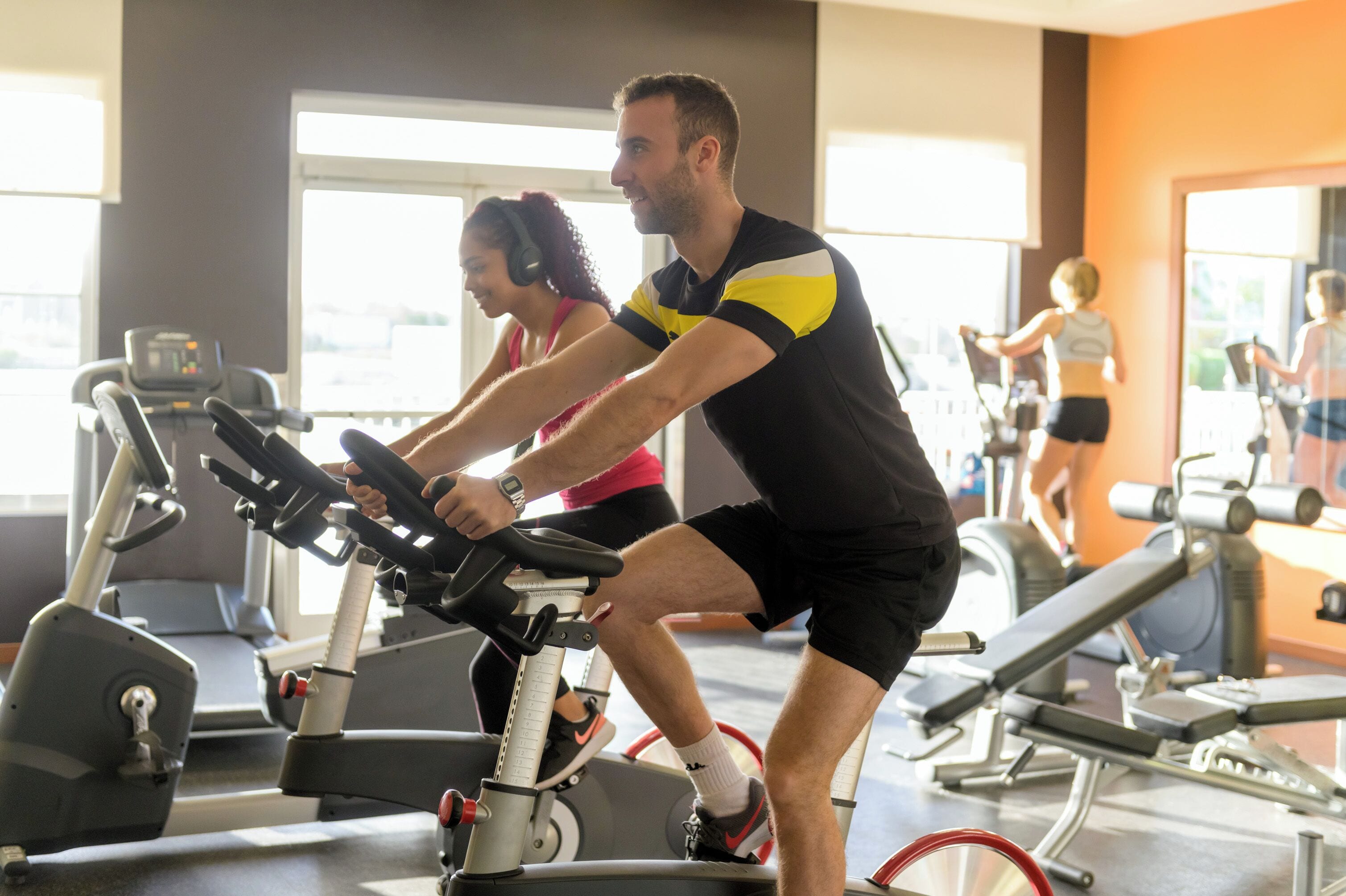 A gym with stationary bikes, a treadmill, and various exercise equipment.