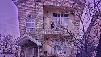 A two-story house with a front porch, a garage, and a "No Parking" sign.