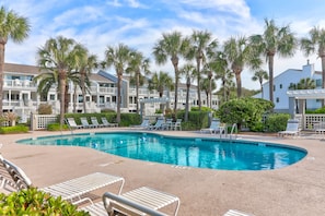 A swimming pool with lounge chairs and palm trees. - Private Screen Porch & Sun Deck w/Ocean Views, Pool Access - 62 Beach Club Villa (Isle Of Palms)
