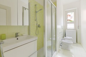 A bathroom with a shower, toilet, and sink. - GuestHost - Jerusalem M5 Yellow Studio with Closed Balcony! (Milano)