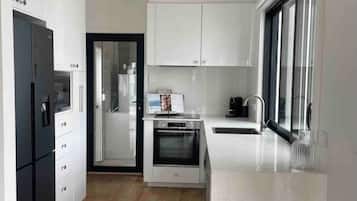 Fridge, coffee/tea maker, cookware/dishes/utensils