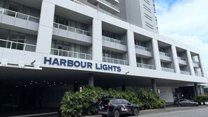 A modern building with a sign reading "HARBOR LIGHTS".