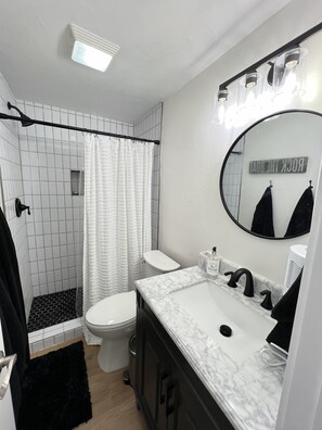 Ein modernes Badezimmer mit Dusche, Toilette und Waschtisch.