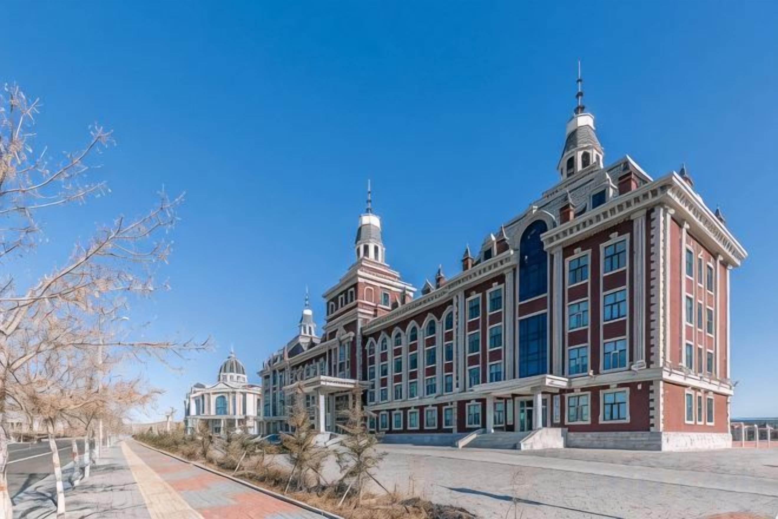 A large, historic building with multiple domes and a prominent tower.
