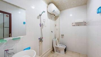 A bathroom with a sink, toilet, and shower.