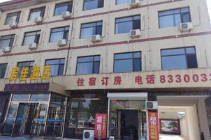 A hotel with multiple floors, air conditioning units, and signage for services like accommodation and telephone.