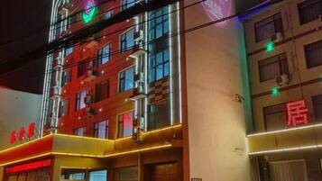 A multi-story hotel with illuminated signage and a prominent entrance.