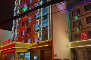 A multi-story hotel with illuminated signage and a prominent entrance.