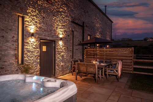 One of 3 cottages, this beautiful barn conversion with a hot tub and EV charger is the perfect place
