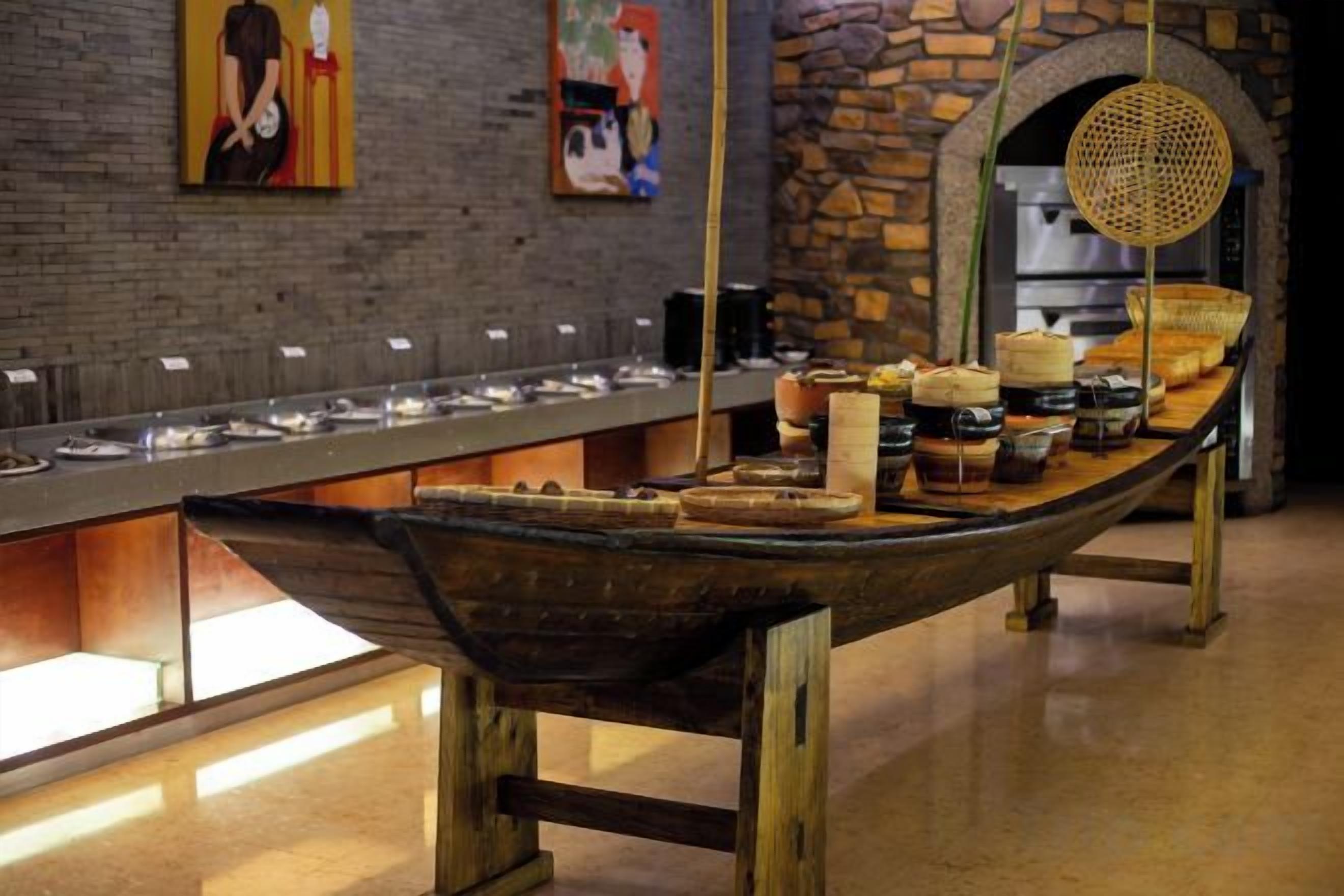 A buffet setup with a long counter and various food items.
