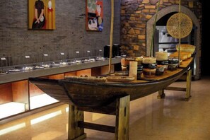 A buffet setup with a long counter and various food items.