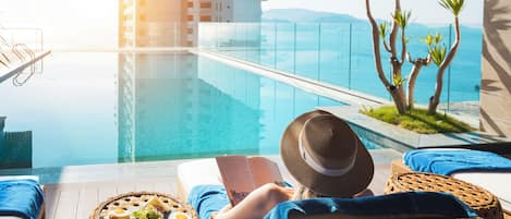 Outdoor pool, open 6:00 AM to 10:00 PM, pool umbrellas, sun loungers