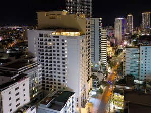 A high-rise hotel with multiple floors, balconies, and a rooftop area. - Gonsala Hotel Nha Trang (Nha Trang)