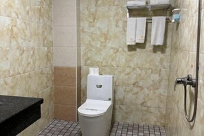 A bathroom with a toilet, a shower, and a towel rack. - Xiaomaoshan Hotel (Nanning)