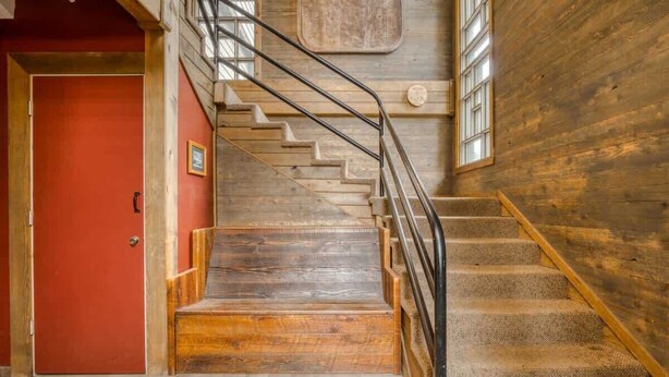 A staircase with wooden steps and metal railings, leading to a red door. - Thunderhead Condo With Heated Pool & Mountain View (Government Camp)