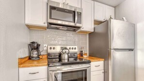 A compact kitchen with a microwave, stove, oven, and refrigerator. - Thunderhead Condo With Heated Pool & Mountain View (Government Camp)