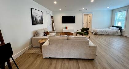 Luxury New 1BR 950 sq ft apartment. Sleeps 4. Stocked Kitchen, 2 Tvs, Parking.