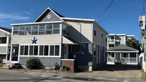 A two-story building with a prominent star on the facade, large windows, and a small porch. - Enjoy a 3-bedroom vacation home steps to the Beach and Hampton Beach State Park (Hampton)