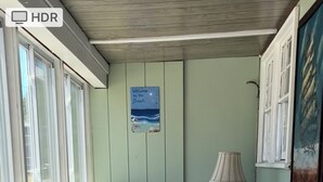 A covered porch with a view of the beach, wicker chairs, a lamp, and a welcome sign. - Enjoy a 3-bedroom vacation home steps to the Beach and Hampton Beach State Park (Hampton)