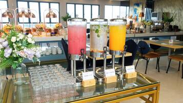 A beverage station with three dispensers labeled 'Guava Juice', 'Infused Water', and 'Mango Juice'.