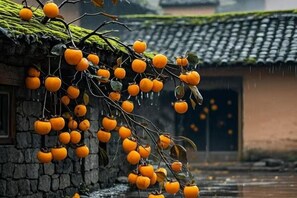 A traditional building with a tiled roof and a stone wall. - A·K·S Fashion Hotel (Wenzhou)