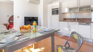 A modern kitchen with white cabinets, a Bosch dishwasher, and a microwave. - Boulevard Louis Blanc by Interhome (Saint-Tropez)