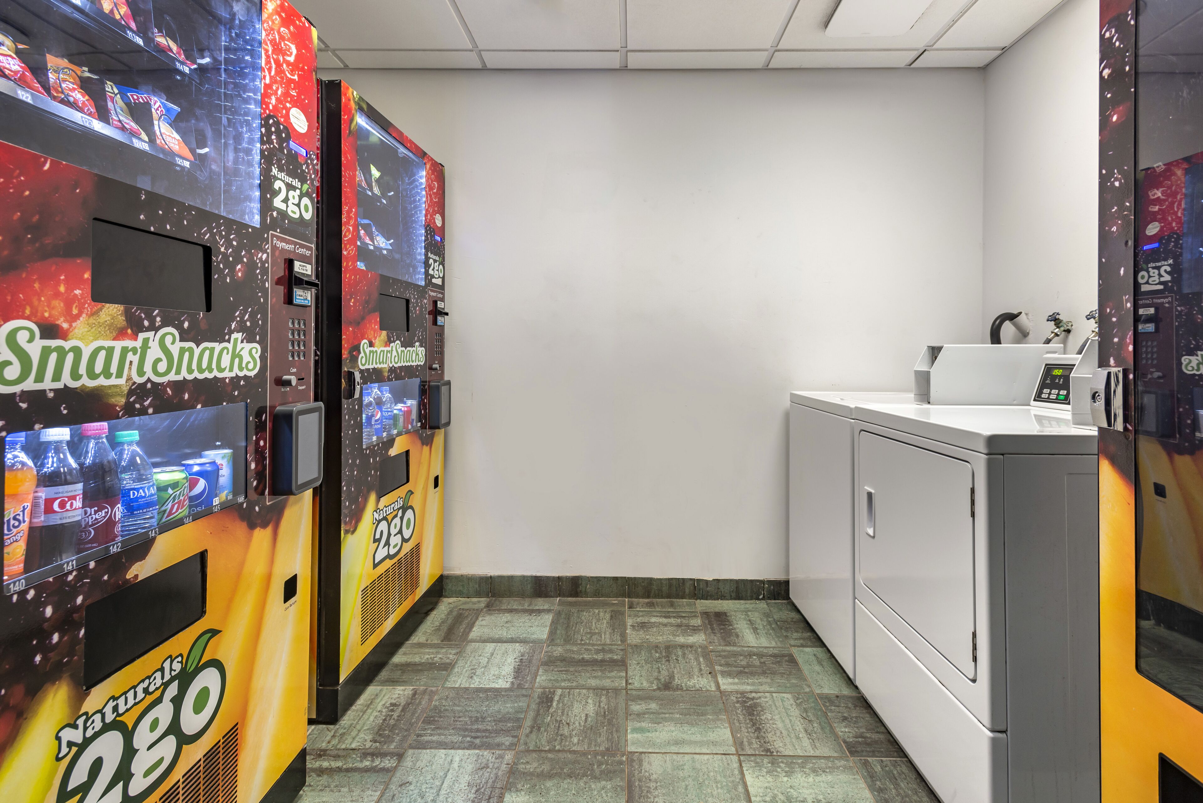 A vending machine area with multiple 'SmartSnacks' machines and a washing machine.