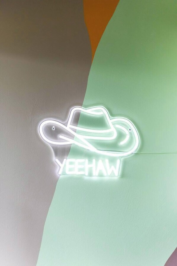 A neon sign with the text "YEEHAW" and a cowboy hat design.