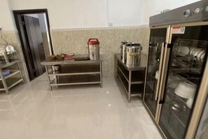 Una cocina con electrodomésticos de acero inoxidable, lavavajillas y refrigerador.