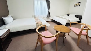 A hotel room with two single beds, a small round table with two chairs, a telephone, and a window with curtains. - GREEN HOTEL AIZU (Aizuwakamatsu)