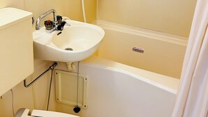 A bathroom with a sink, mirror, toilet, and bathtub. - GREEN HOTEL AIZU (Aizuwakamatsu)