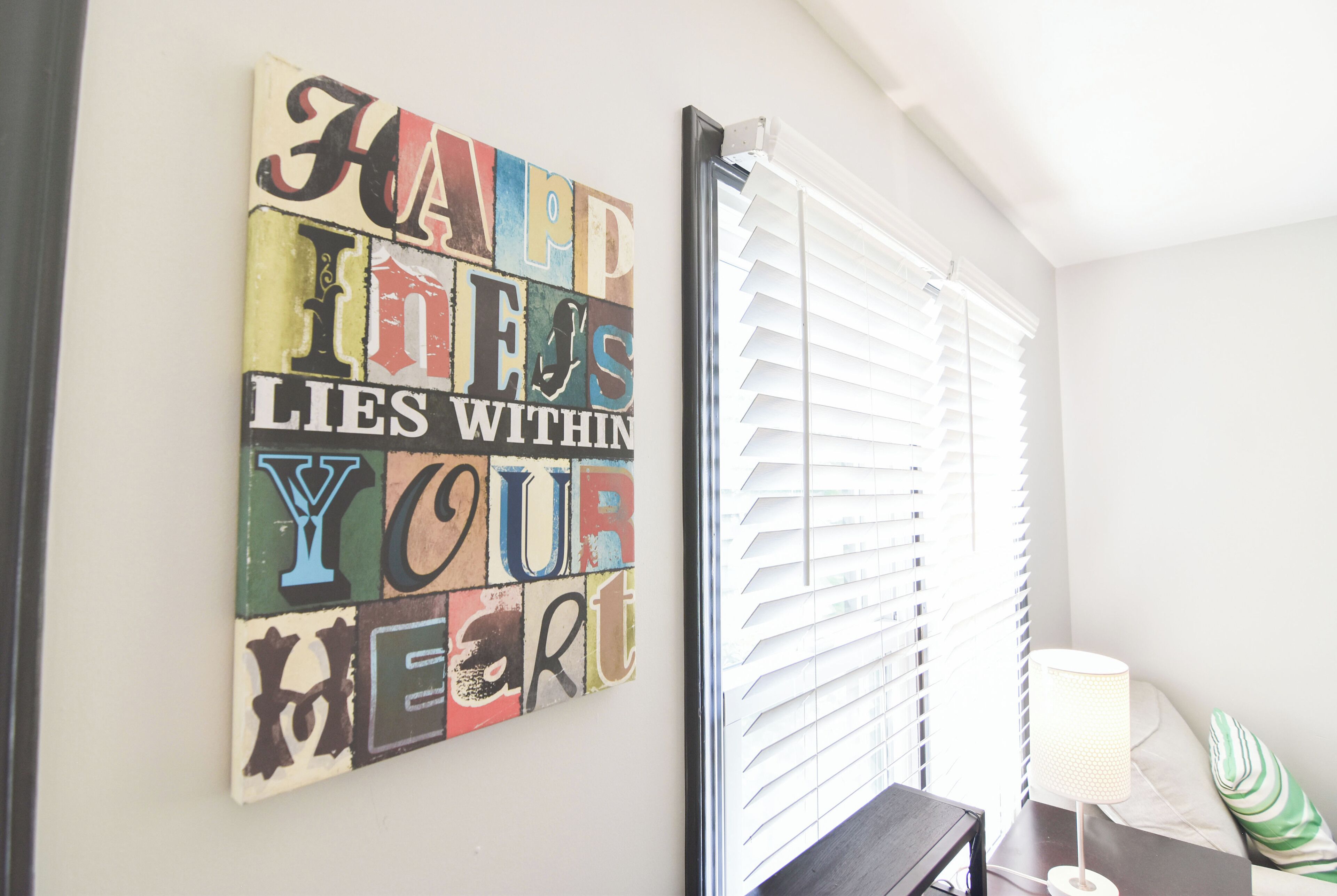 A wall with a colorful quote art piece.