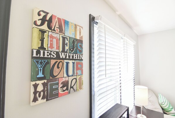 A wall with a colorful quote art piece.
