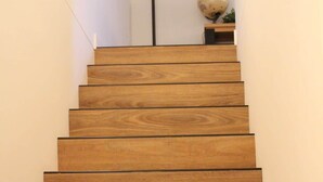A wooden staircase with a light fixture at the top.