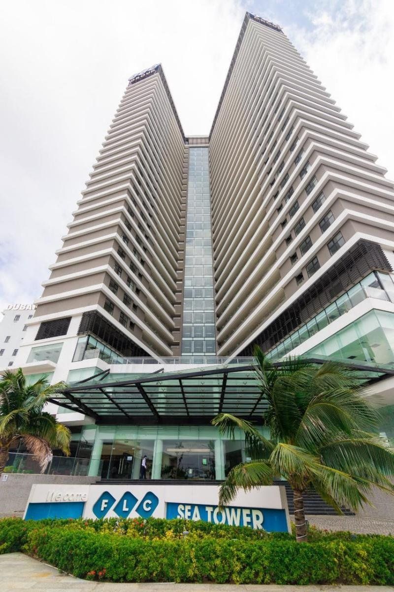 A modern hotel with a unique architectural design featuring two tall, mirrored towers.
