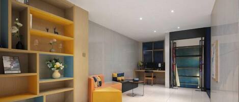 A modern living room with a sofa, a coffee table, and a bookshelf.