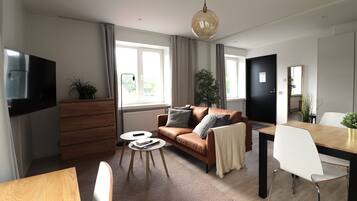 A modern living room with a sofa, coffee table, and dining table.