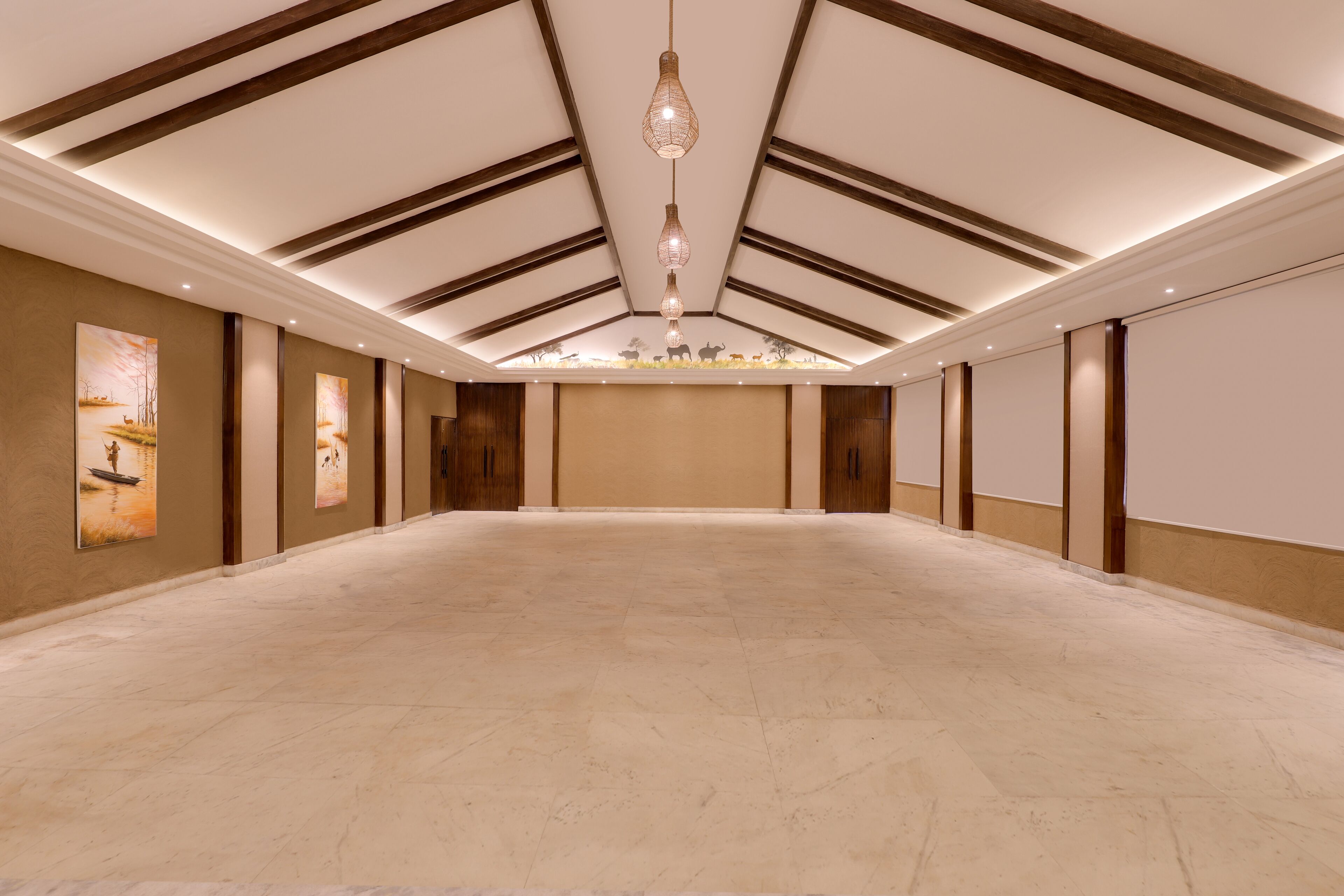 A spacious conference room with a high ceiling, wooden beams, and a central hanging light fixture.