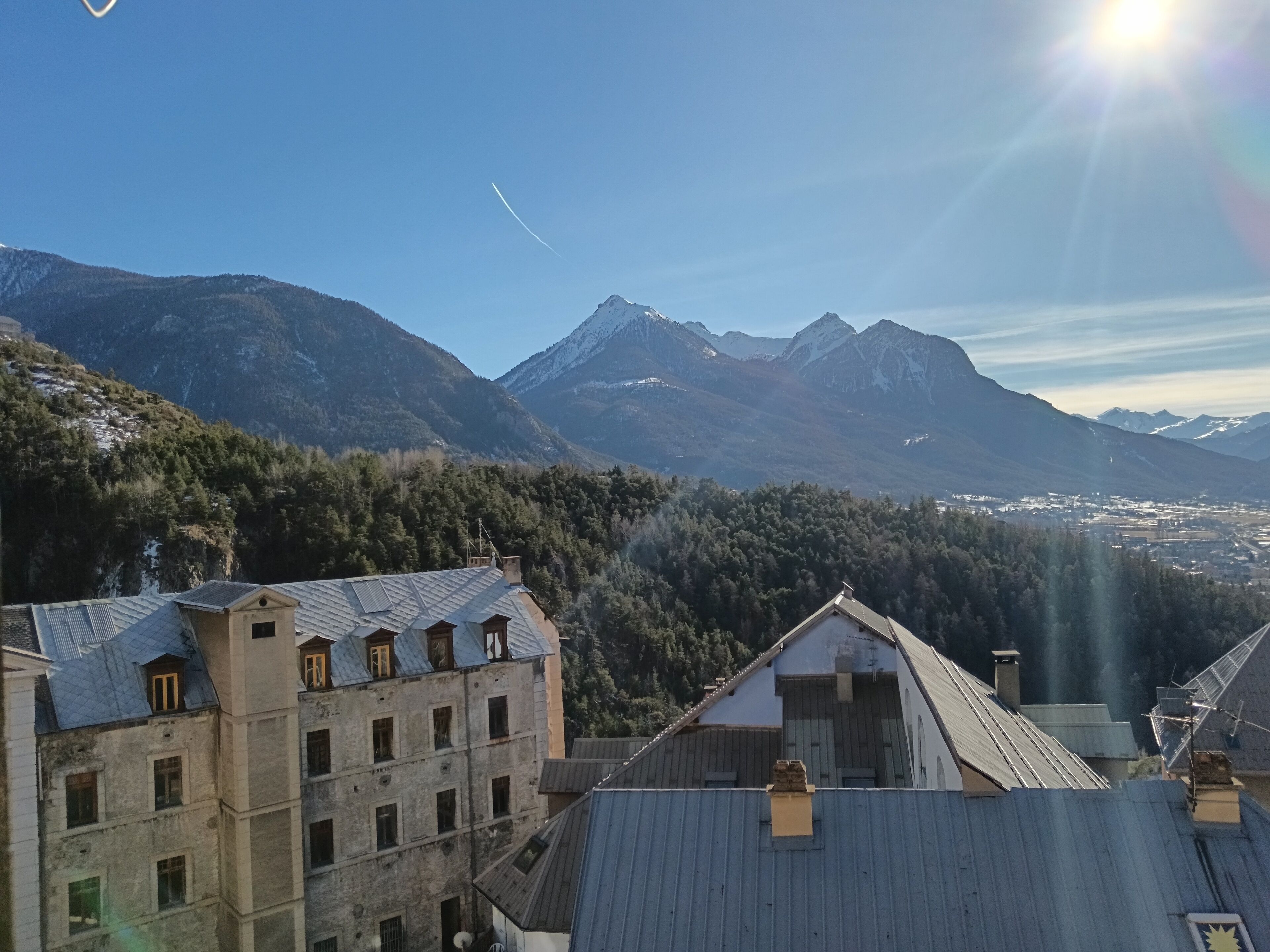 A mountainous landscape with buildings in the foreground.