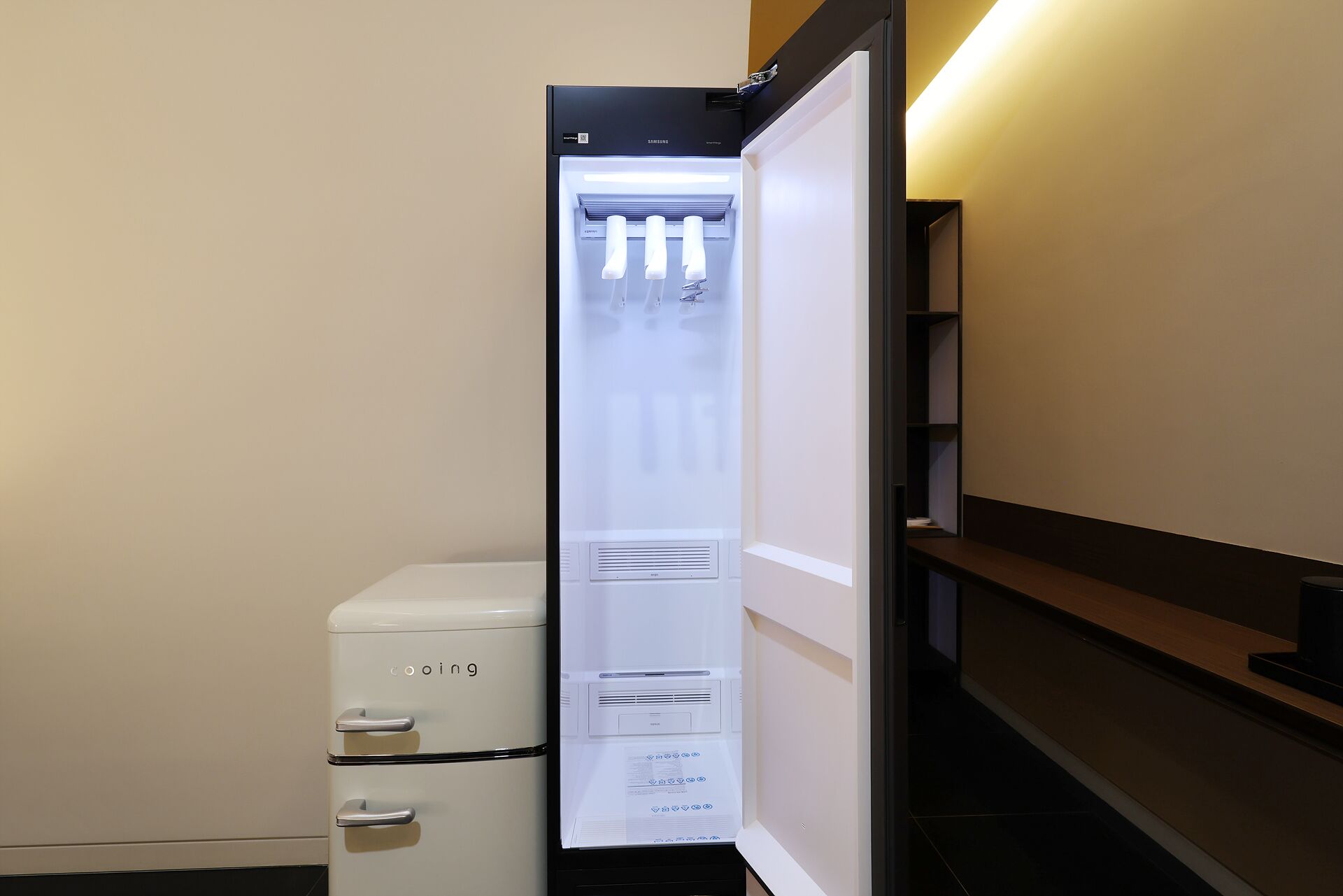 A compact refrigerator with a freezer compartment, a water dispenser, and a control panel.