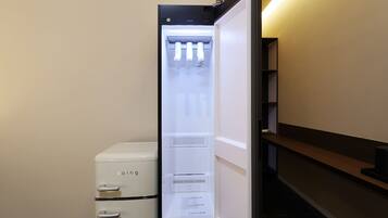 A compact refrigerator with a freezer compartment, a water dispenser, and a control panel.