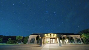 A building with a sign reading "HOUSTON SPACE JAPAN" under a starry night sky. - HOTEL HOLISTIC RESORT (Taiji)