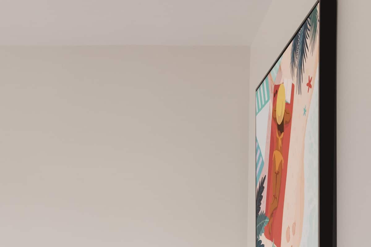 A modern bedroom with a bed, white pillows, a white bedside table, and a wall-mounted painting.