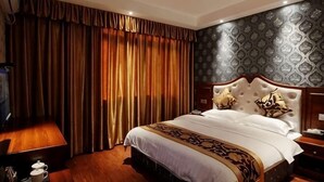 A hotel room with a large bed, a wooden nightstand, a bedside table, and a wall-mounted TV. - Ligang Hotel (Chongqing)